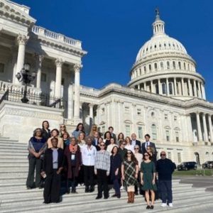 Group of people standing in front of the US Capitol Building